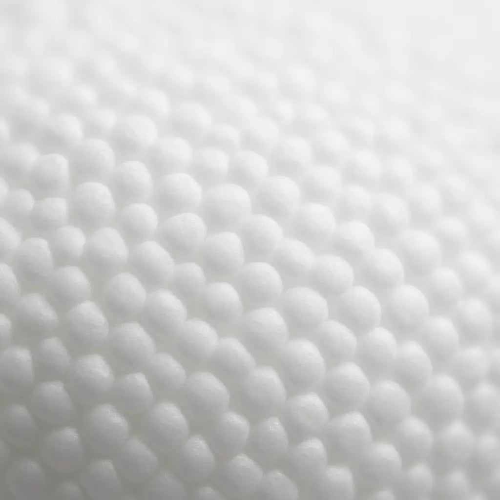 Abstract macro close-up of lightweight foam texture, soft white/neutral tones, minimalist and clean, representing expanded polystyrene